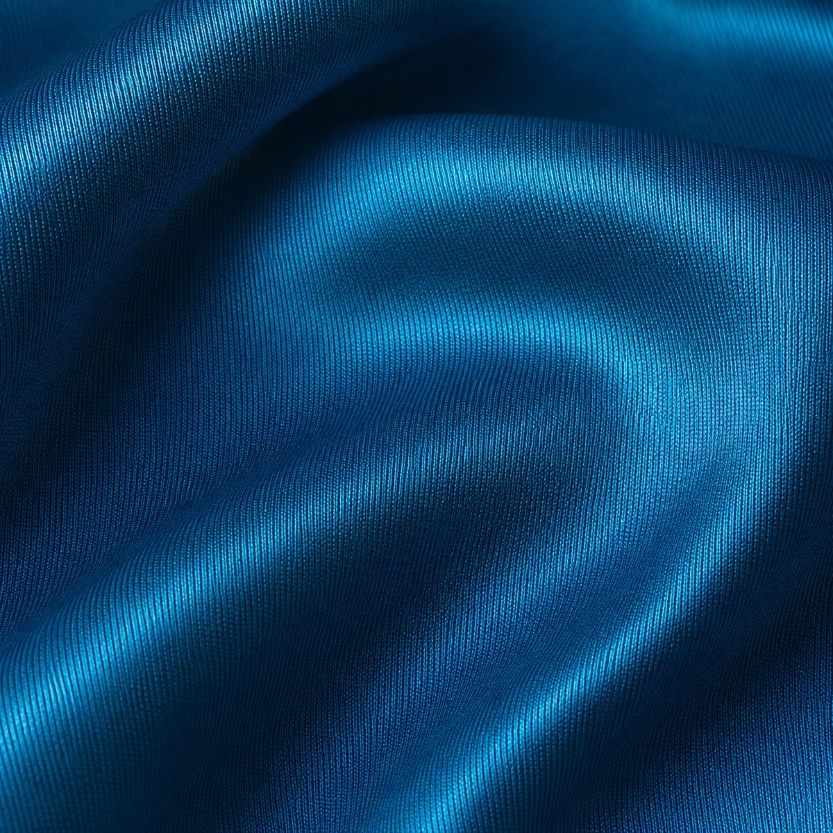 Close-up of dark turquoise satin fabric from the Estrella Swim Ursula bikini set.