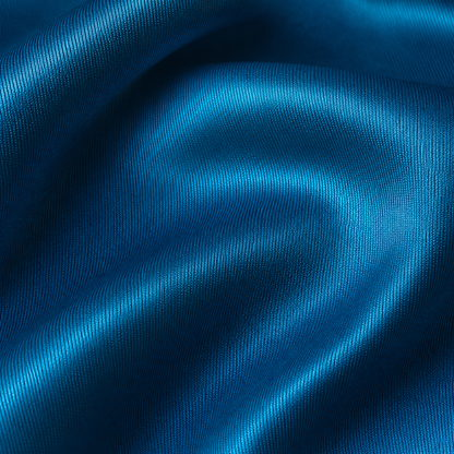 Close-up of dark turquoise satin fabric from the Estrella Swim Ursula bikini set.