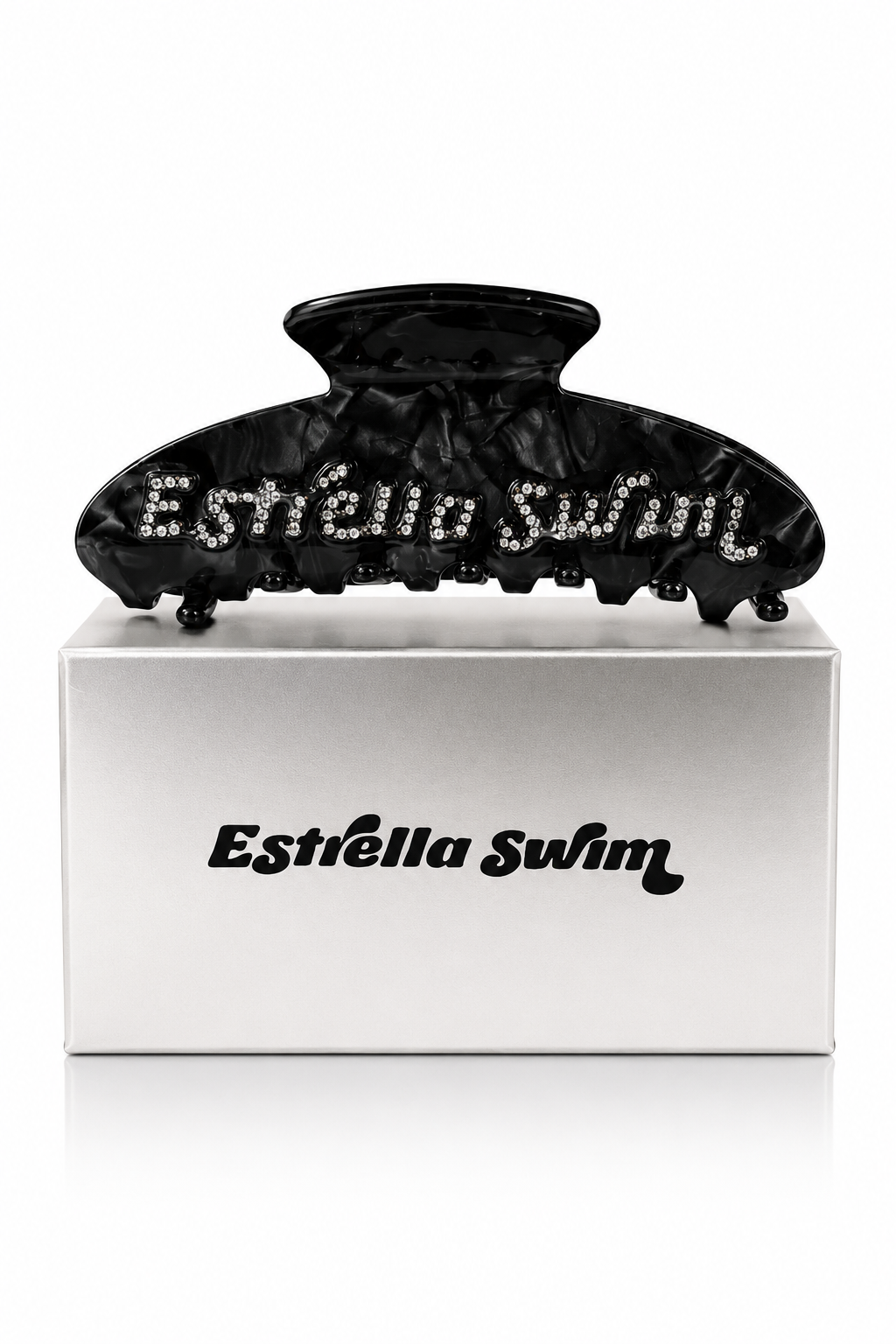 Estrella Swim black hair claw clip displayed on branded packaging box.