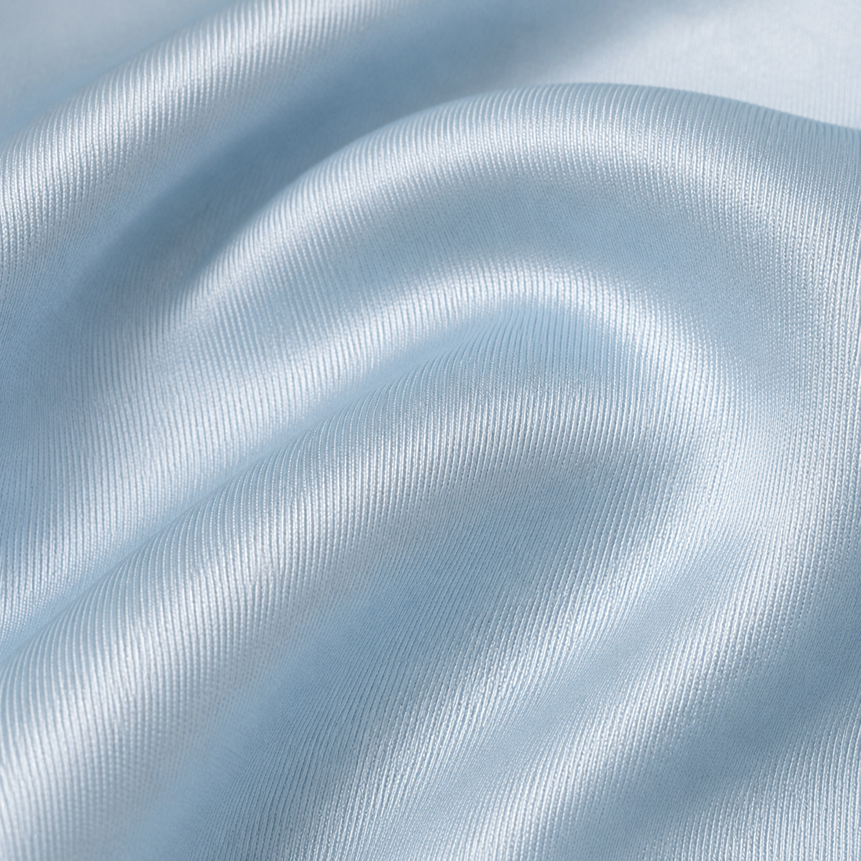 Close-up of Estrella Swim baby blue satin fabric texture.