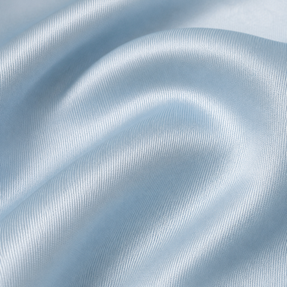 Close-up of Estrella Swim baby blue satin fabric texture.